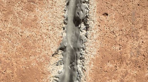 Close-up of a crack in the foundation, filled with a sealant