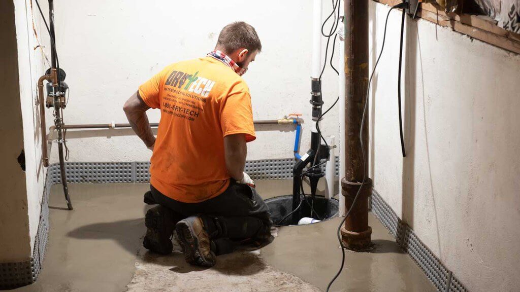 Technician looking at basement sump pump