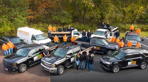 Group photo of Dry Tech Waterproofing Solutions employees and company vehicles
