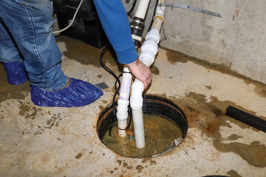Sump pump in a basement being repaired